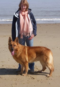Abi Francis on the beach with her dog